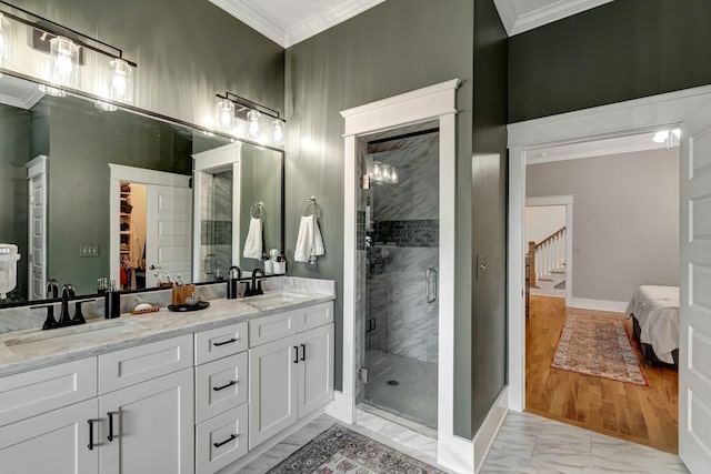 bathroom with vanity, crown molding, and walk in shower