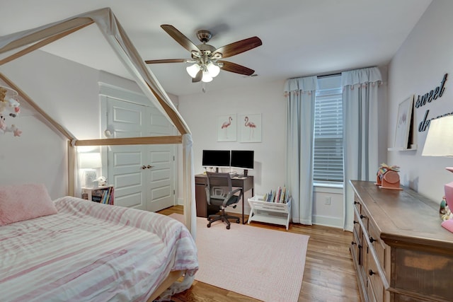 bedroom with ceiling fan and light hardwood / wood-style flooring