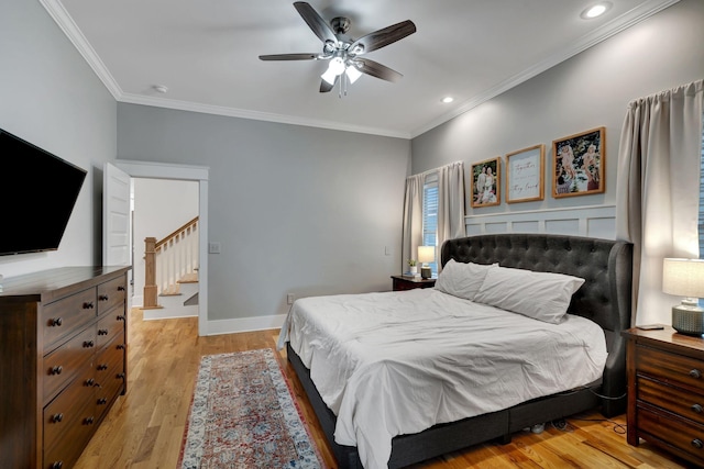 bedroom featuring ceiling fan, light hardwood / wood-style floors, and ornamental molding