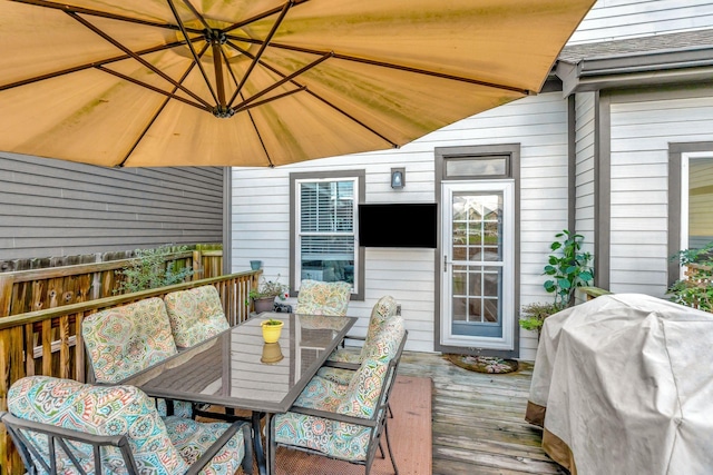 wooden deck with outdoor lounge area and grilling area