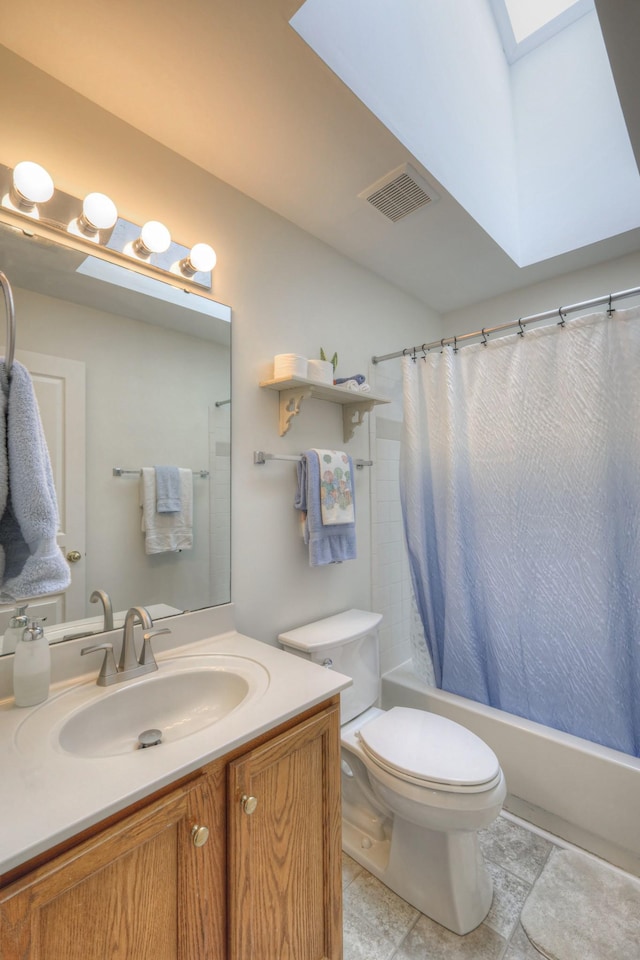 full bathroom featuring vanity, toilet, shower / bathtub combination with curtain, and a skylight