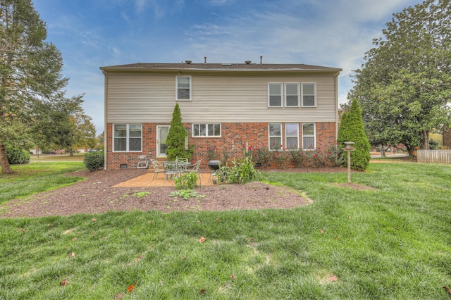 back of property with a patio area and a yard