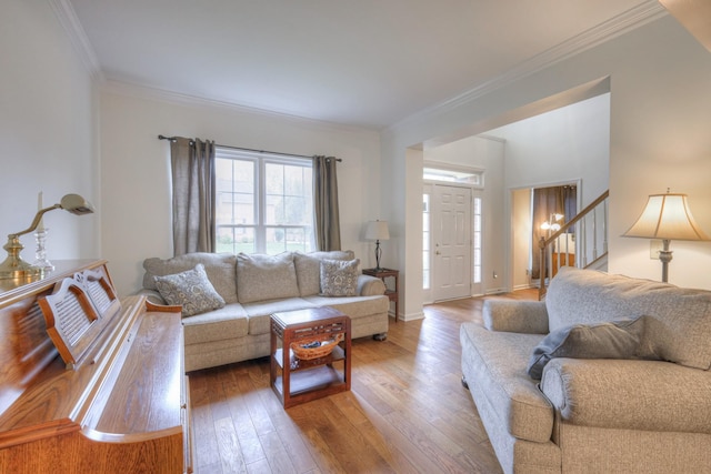 living room featuring crown molding and light hardwood / wood-style floors