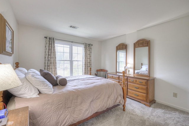 bedroom with light colored carpet