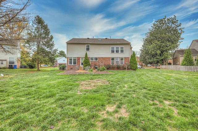 rear view of house with a yard