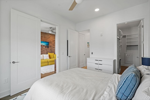 bedroom featuring a spacious closet, a closet, and ceiling fan