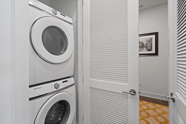 laundry area featuring stacked washer and dryer