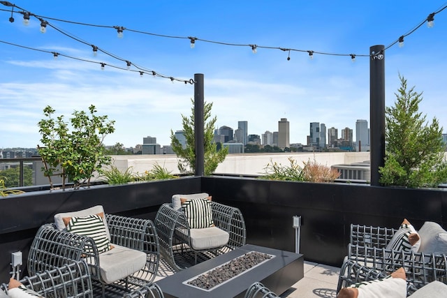 view of patio / terrace with an outdoor living space with a fire pit