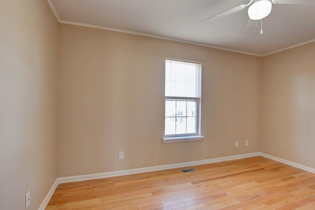 empty room featuring visible vents, baseboards, ceiling fan, light wood-style floors, and crown molding