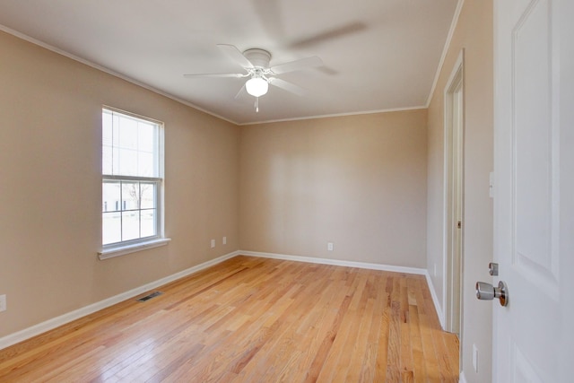 unfurnished room featuring baseboards, visible vents, ceiling fan, ornamental molding, and light wood-type flooring