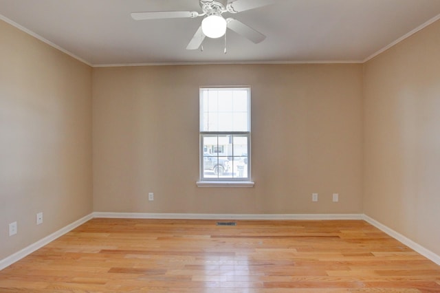 empty room with light wood-type flooring, visible vents, and ornamental molding