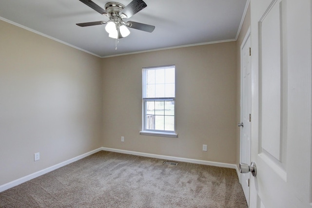 unfurnished bedroom featuring visible vents, baseboards, ornamental molding, carpet flooring, and a ceiling fan