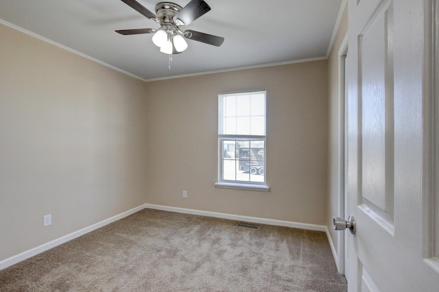 unfurnished room featuring crown molding, carpet, and visible vents