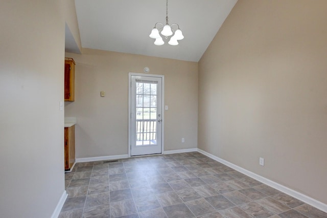 entryway with a notable chandelier, lofted ceiling, and baseboards