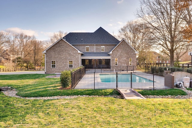 view of pool featuring a patio area, fence, a fenced in pool, and a yard