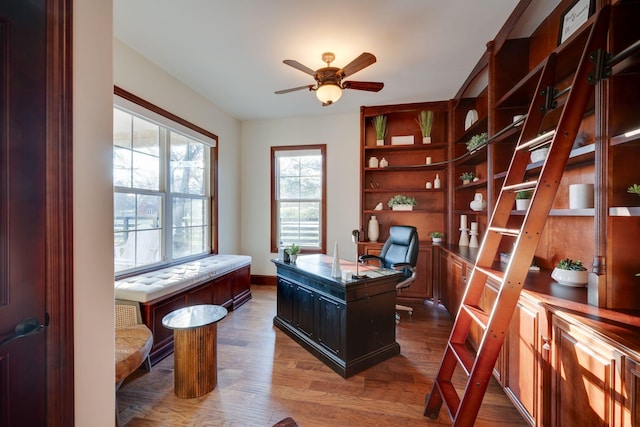 office space with wood finished floors and a ceiling fan