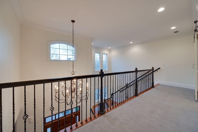 hallway featuring baseboards, recessed lighting, an inviting chandelier, and crown molding