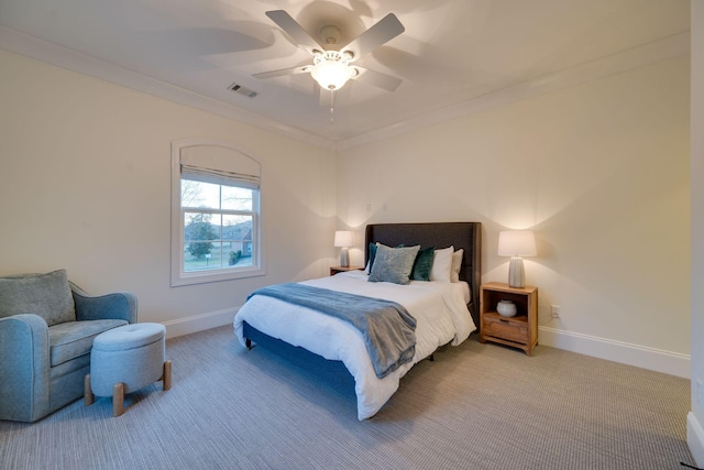 bedroom with visible vents, crown molding, light carpet, and baseboards