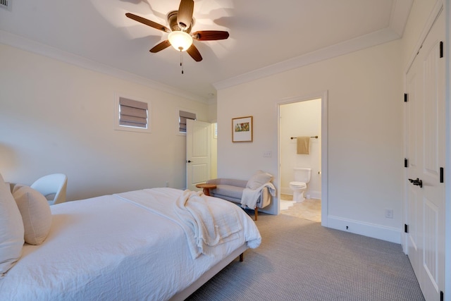 bedroom featuring crown molding, ensuite bathroom, light carpet, ceiling fan, and baseboards