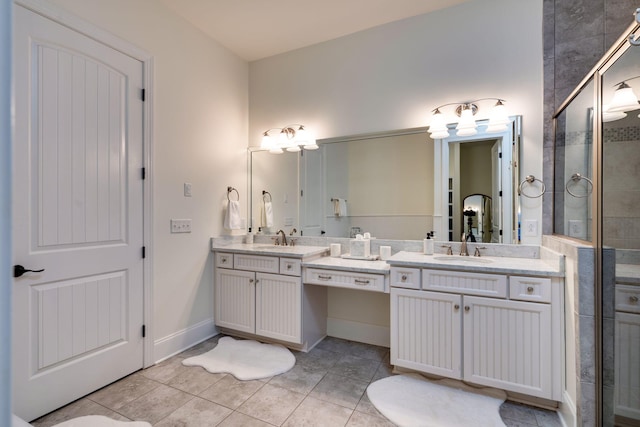 full bath with a stall shower, tile patterned flooring, baseboards, and vanity