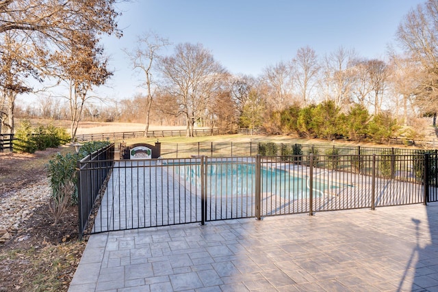 view of pool featuring a patio area, fence, and a fenced in pool