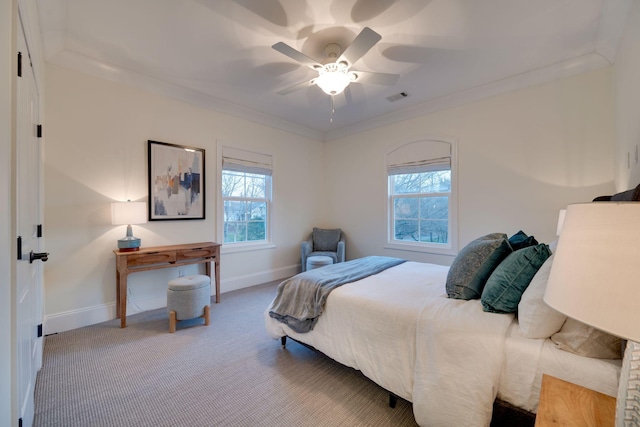 bedroom featuring ornamental molding, carpet, visible vents, and multiple windows