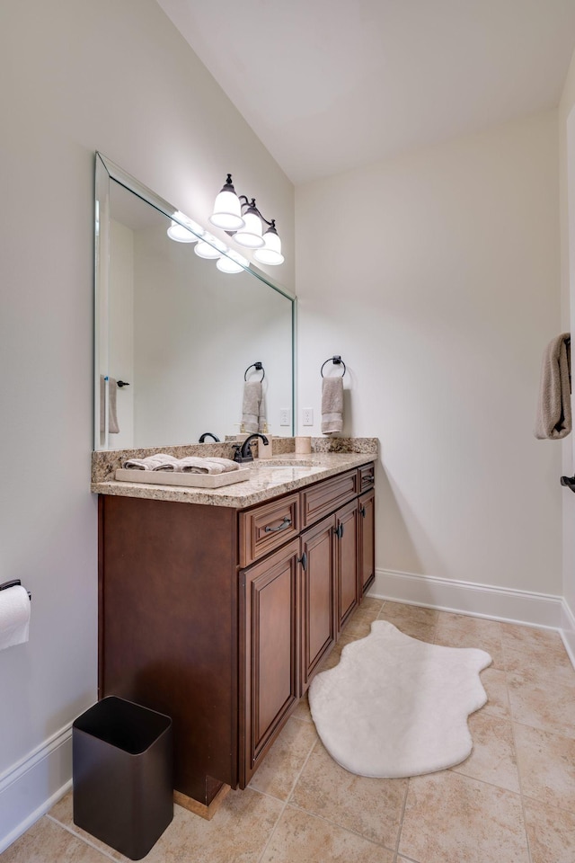 bathroom featuring tile patterned flooring, vanity, and baseboards