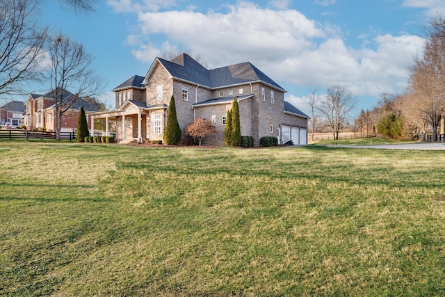 view of home's exterior featuring an attached garage, brick siding, fence, and a yard