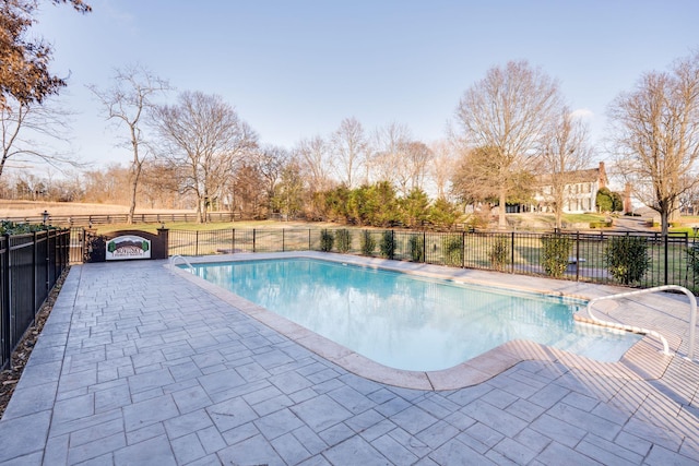 view of pool with a fenced in pool, a patio area, and fence