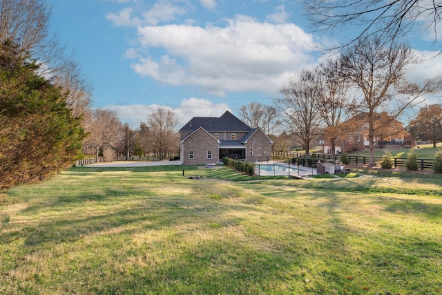 view of yard with fence and a fenced in pool