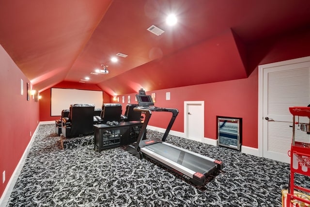 workout area with lofted ceiling, carpet, visible vents, and baseboards