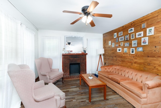 living room featuring a brick fireplace, wood walls, ceiling fan, and hardwood / wood-style flooring