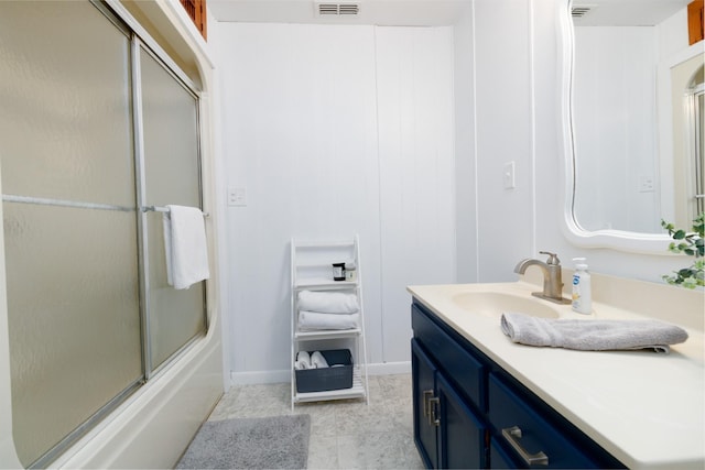 bathroom with vanity and enclosed tub / shower combo