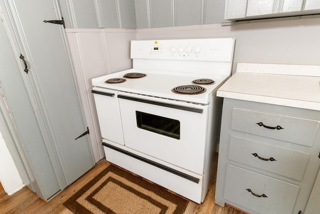 kitchen featuring white range with electric cooktop and light wood-type flooring