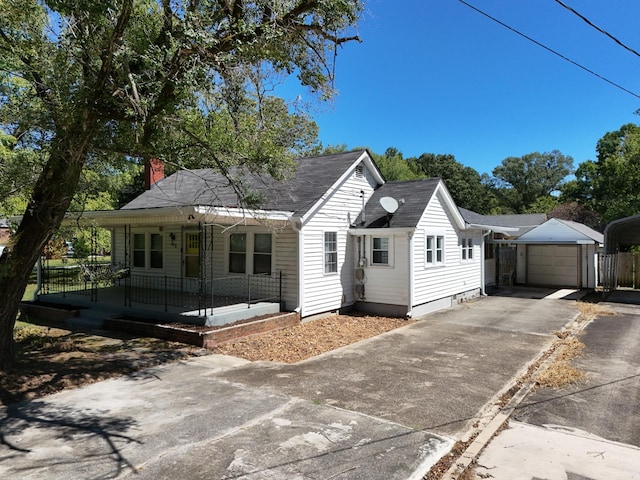 view of front of property with an outdoor structure, a porch, and a garage