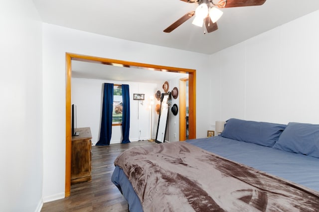 bedroom with ceiling fan and dark hardwood / wood-style floors