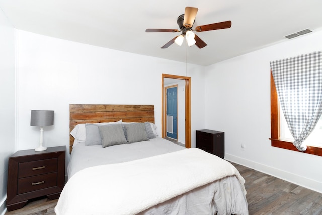 bedroom featuring dark hardwood / wood-style flooring and ceiling fan