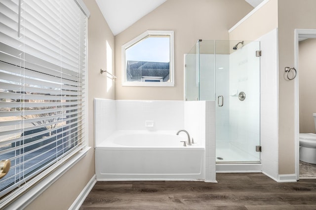 bathroom featuring toilet, plus walk in shower, vaulted ceiling, and hardwood / wood-style flooring