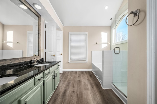 bathroom featuring vanity, hardwood / wood-style flooring, and independent shower and bath