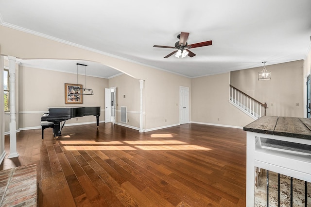 living room featuring dark wood-type flooring, ceiling fan, and crown molding