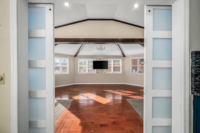 living room with built in shelves, vaulted ceiling, and wood-type flooring