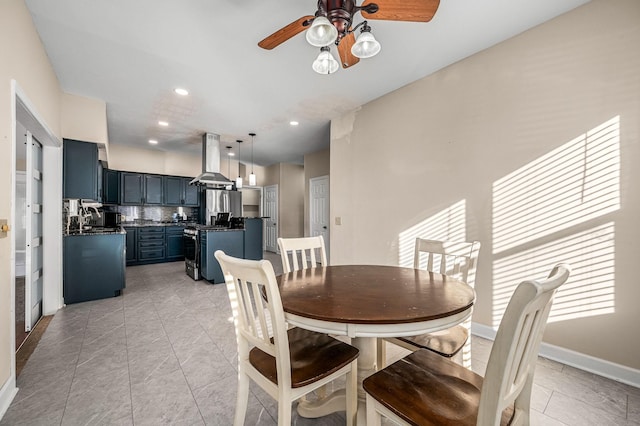 tiled dining room with ceiling fan and sink