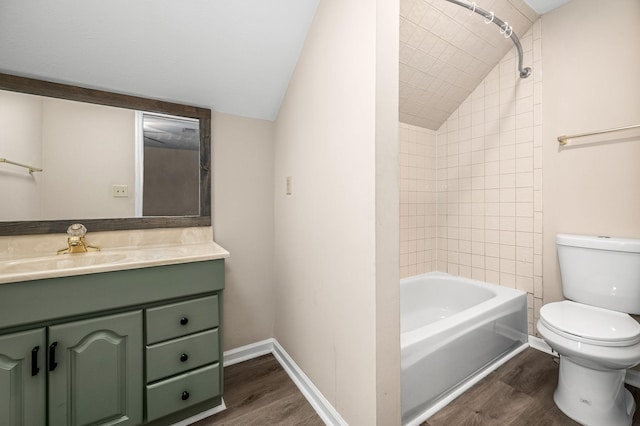 full bathroom with hardwood / wood-style flooring, vanity, toilet, and vaulted ceiling