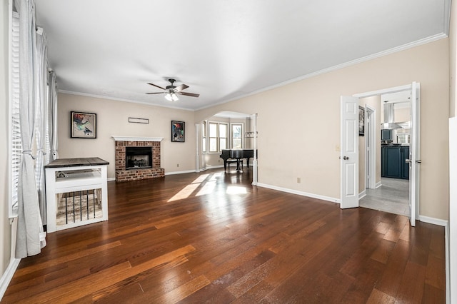 unfurnished living room with crown molding, ceiling fan, and dark wood-type flooring