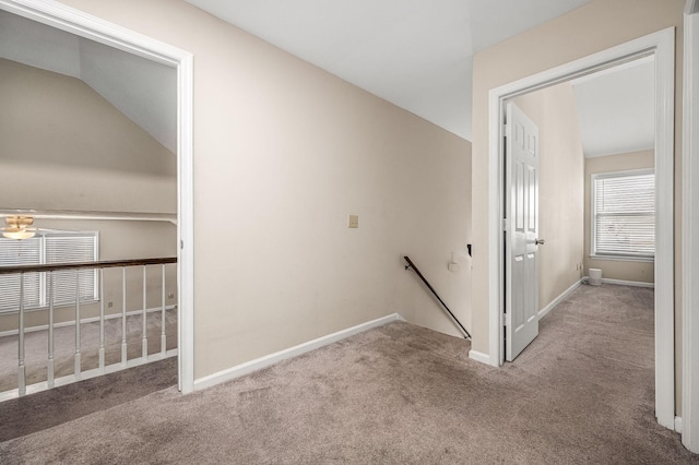 stairway featuring carpet floors and vaulted ceiling