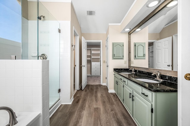 bathroom featuring hardwood / wood-style floors, vanity, and independent shower and bath