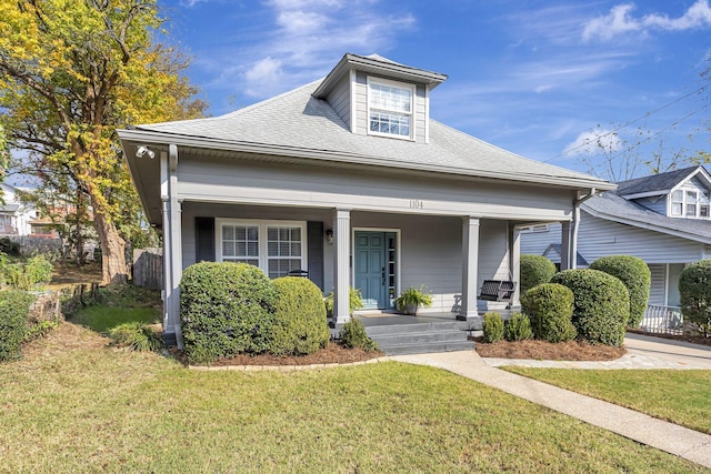 view of front of property with covered porch and a front lawn