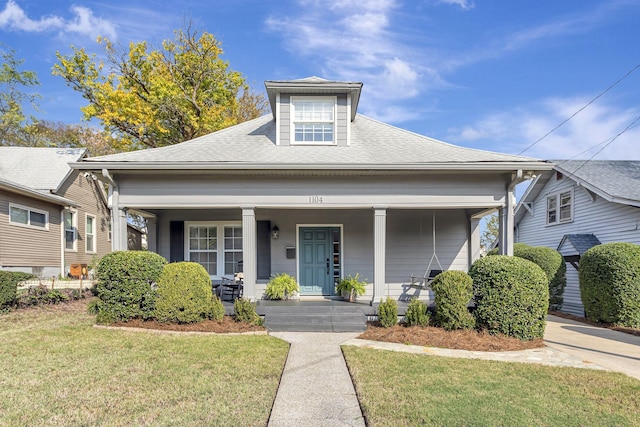 bungalow-style home featuring a front lawn and a porch