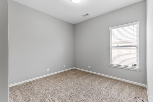 carpeted empty room with a healthy amount of sunlight