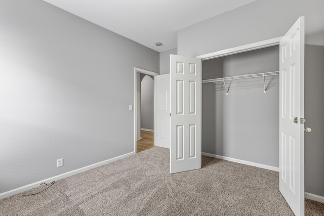 unfurnished bedroom with a closet and carpet floors